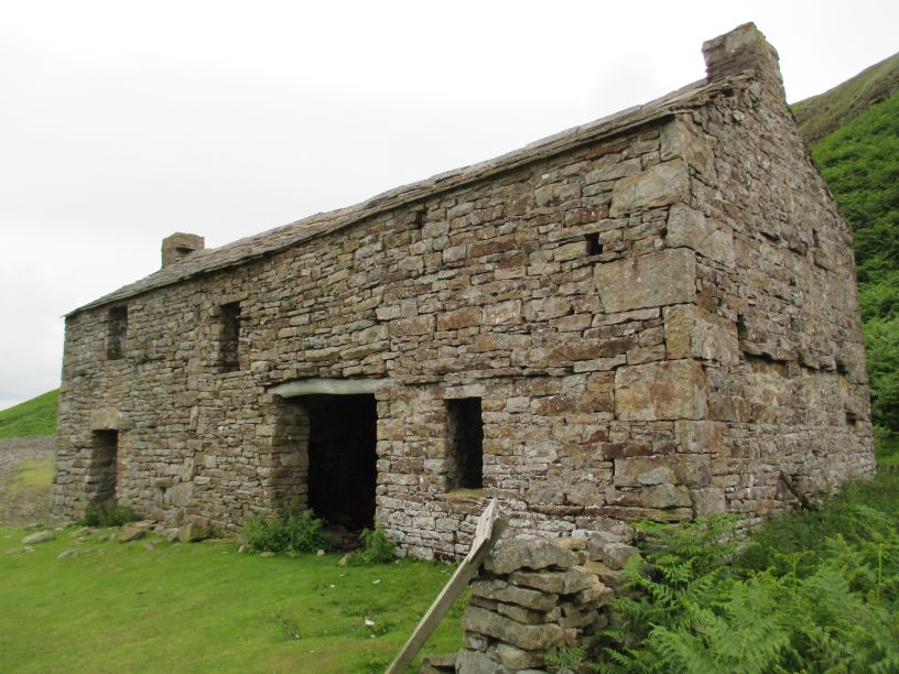 The abandoned ruined Crackpot Hall Farmhouse, high above the Rive Swale, Swaledale North Yorkshire Dales National Park England