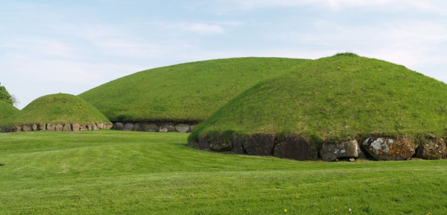 42. The kerb stone surrounded and grass covered burial chambers in the Knowth prehistoric monument tombs above the River Boyne, Co. Meath, Ireland.