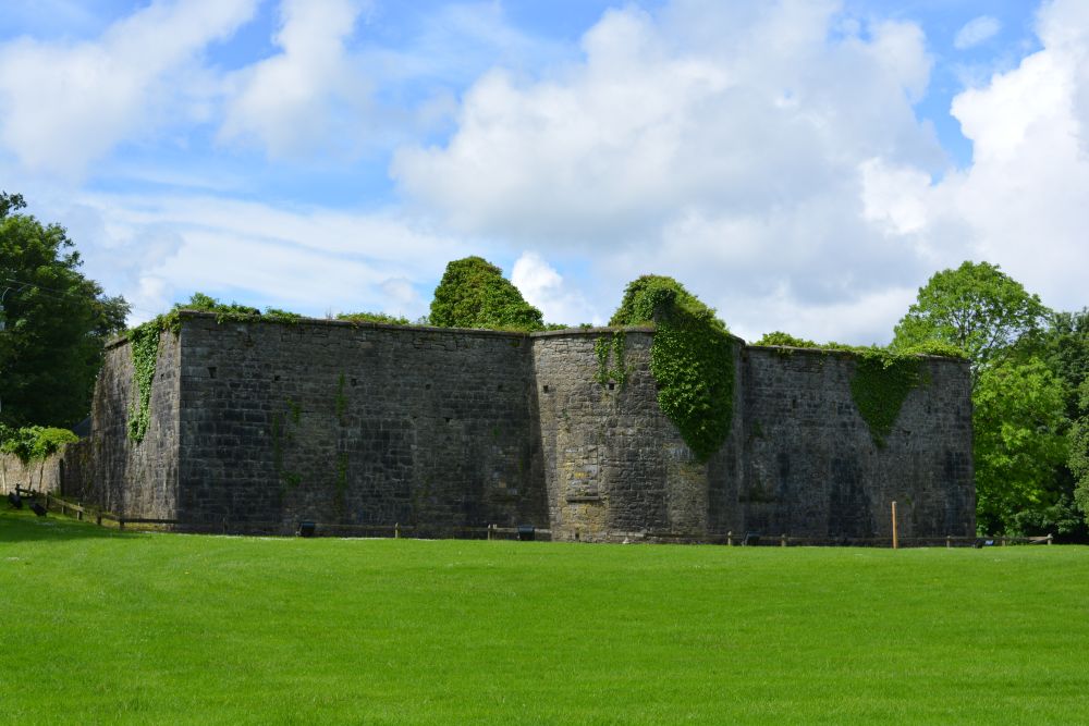 The ruins of the original Turlough house (occupied 1722-1786) and a round tower National Museum of Country Life, Co. Mayo, Ireland