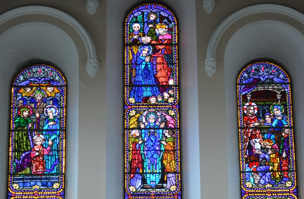 Details of the upper stained glass panels by Harry Clarke bright colours and fine outlines Church of the Nativity of the Blessed Virgin Mary, Timoleague, Co. Cork, Ireland