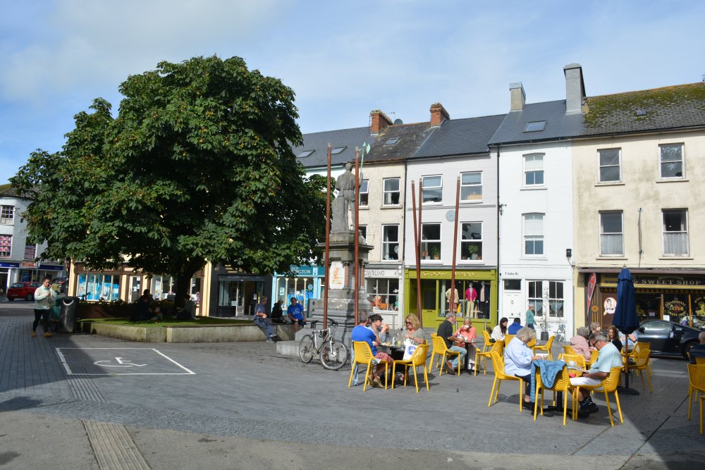 musician plays in Astna Square, off Ashe Street Clonakilty, statue to Tadhg O�Donovan Astna 1798 Rebellion Co. Cork, West of Ireland