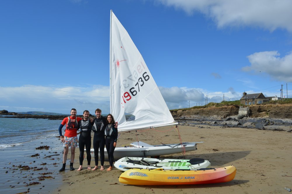 A sailing crew and their yacht on Garrylucas Beach (White Strand) Co. Cork, West of Ireland