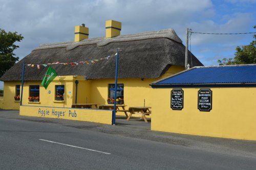 The colourful Aggie Hayes pub in Killea, a quaint old Irish pub and good music venue, across the road from the ruined church. Dunmore East, Co. Waterford, Ireland