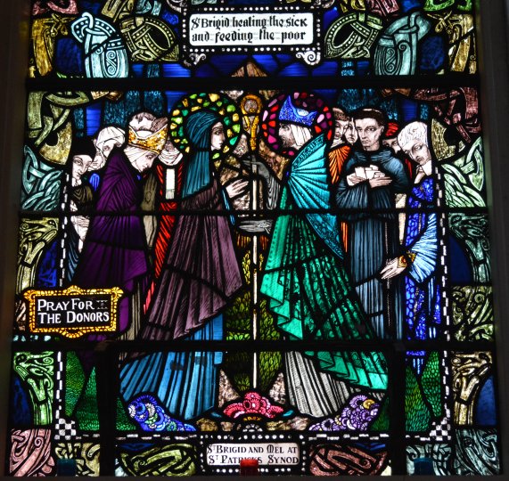 stained glass window depicting St Brigid healing the sick and feeding the poor St. Senan's Roman Catholic Church, Kilrush, Co. Clare