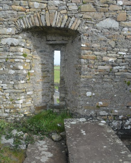 Old ancient slit window of Church of Saint John the Baptist at Killballyowen outside Cross on the Loop Head Peninsula, Co Clare