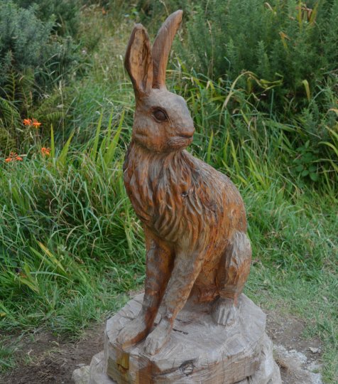A Connemara pony and wooden Irish hare sculpture on the way up Diamond Mountain Connemra National Park Centre, Co. Galway, Ireland