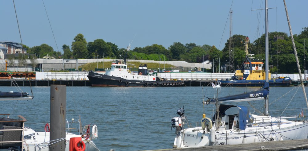 Looking across from Waterford's Millennium Plaza towards tugboats moored on the north bank of the River Suir Waterford Waterfront