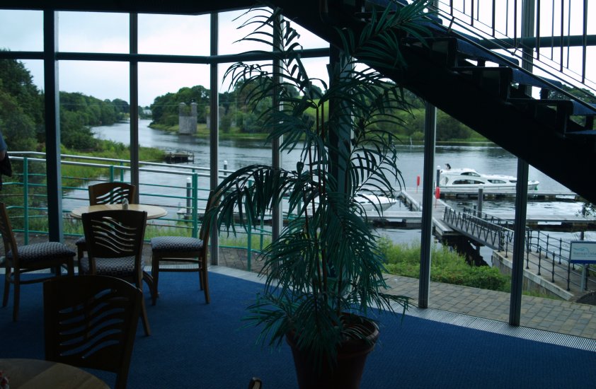 66. The fine setting of the Theatre, Enniskillen, Co. Fermanagh, Northern Ireland (NI). A fine piece of modern architecture set on the shores of Lough Erne, a landing pier in the foreground and the remains of the railway bridge that one once carried the line from Belfast into Enniskillen.