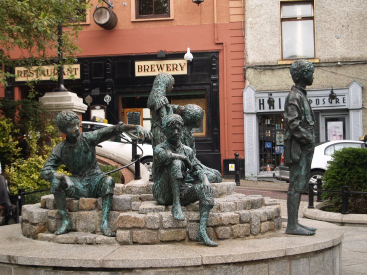 137. The reflective 'Hiring Fair' sculpture in Market Square in the busy, bustling and expanding town of Letterkenny, Co. Donegal, Ireland.