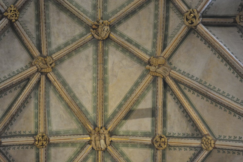 boss heads on the vaulting of the ceiling of the nave of Tewkesbury Abbey Gloucestershire England