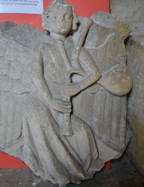 Sculpture of an angel playing the bagpipes Tewkesbury Abbey Gloucestershire England