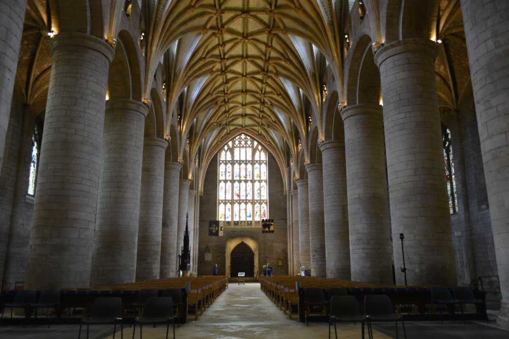 Looking west down the nave to the west window of Tewkesbury Abbey Gloucestershire England