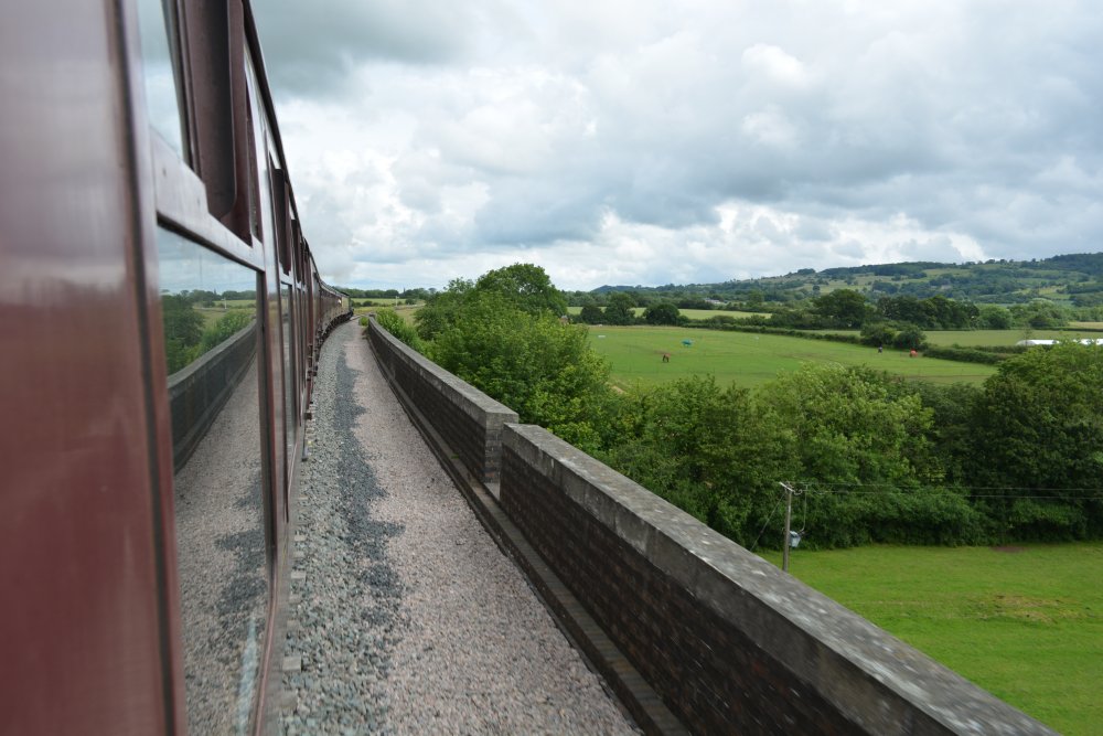 steam train passing over the 15 arches of the Stanway Viaduct between Toddington and Broadway Gloucestershire Warwickshire steam railway England