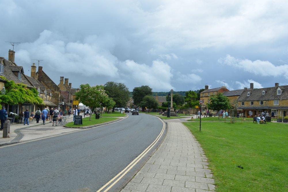 A general view of the High Street, The Green and War Memorial in Broadway Cotswolds village Worcestershire England