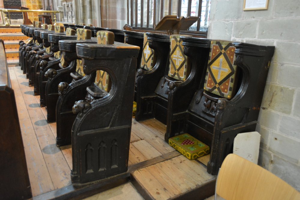 Misericord seating in the choir of Great Malvern Priory Church Worcestershire England