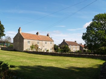 Cold Kirby is essentially a one, wide street village with a number of attractive stone houses, most of which have a lovely flower garden - Walking from Sutton Bank National Park Visitor Centre, North York Moors National Park, North Yorkshire, Northern England