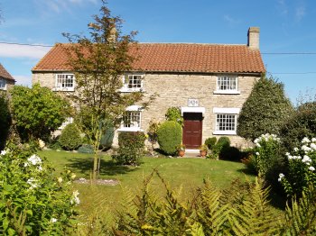 Cold Kirby is essentially a one, wide street village with a number of attractive stone houses, most of which have a lovely flower garden - Walking from Sutton Bank National Park Visitor Centre, North York Moors National Park, North Yorkshire, Northern England