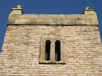 Some authentic early Norman windows high on the tower of St Michael's Church, Cold Kirby Village - Walking from Sutton Bank National Park Visitor Centre, North York Moors National Park, North Yorkshire, Northern England