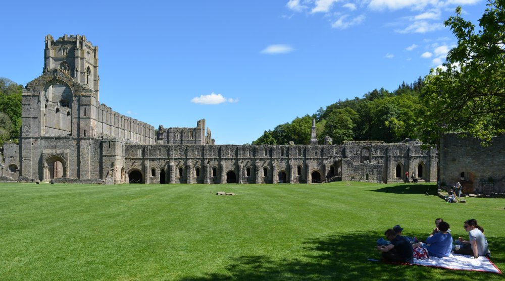 view looking directly at the exterior west wall of the cellarium Fountains Abbey