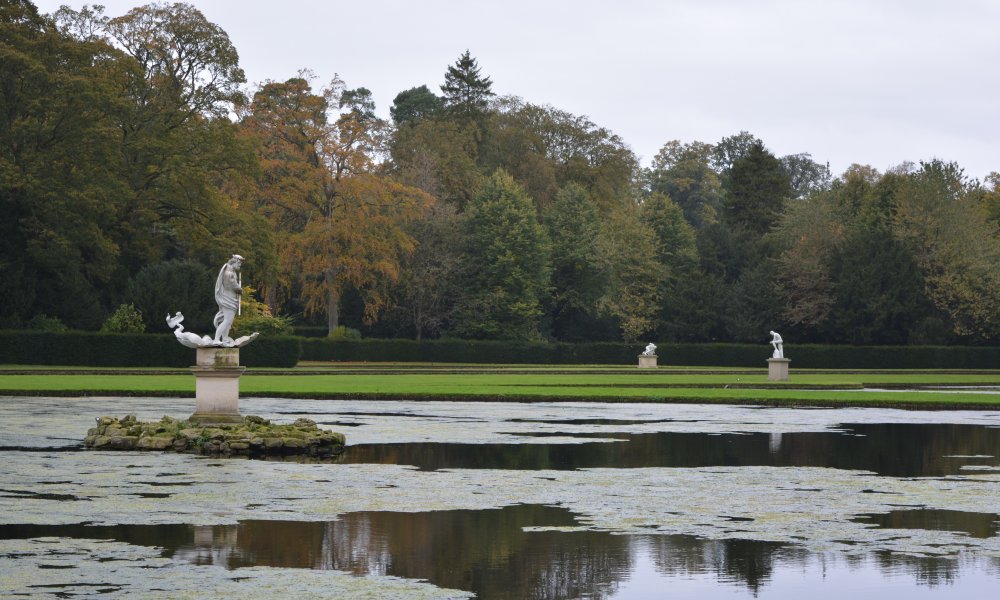 Neptune sculpture and Moon pond Studley Royal walks park gardens in Autumn