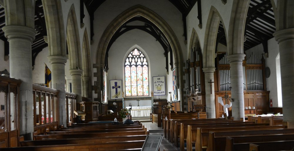 Looking east down the nave of St Margarets' into the chancel and altar area, above is an attractive stained glass east window. Market Town of Hawes