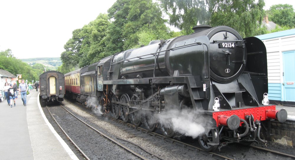 A good portrait of 9F 2-10-0 freight locomotive 92134 at Grosmont station with an NYMR service to Pickering 92024).